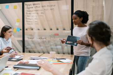 African american office employee creating project with coworker