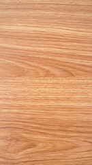 A close-up of a wooden surface, showcasing the intricate grain patterns and warm, brown hues. The texture and detail of the wood create a natural and rustic aesthetic.