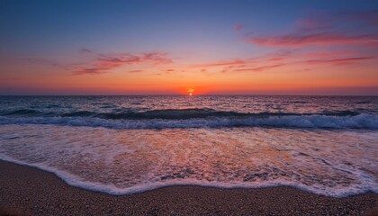 Fototapeta premium Waves on the beach at red sunset