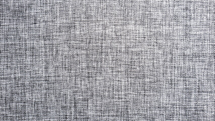 A close-up of a textured fabric with a fine, woven pattern. The neutral color palette and subtle texture create a minimalist and sophisticated aesthetic...