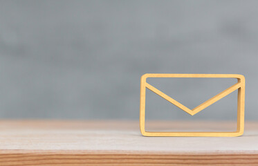Email Icon for Business Communication on Wooden Surface