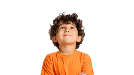 Smiling boy looking up, wearing an orange shirt, isolated.