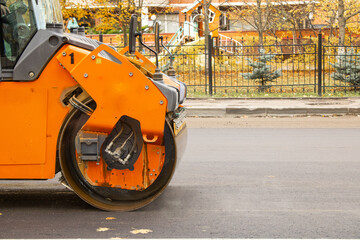 Close-up view of a road roller working at a new road construction site