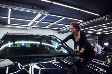Technician polishing the car windshield