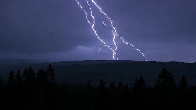 lightening on a rural hilly landscape with a pine forest in the foreground, at nighttime