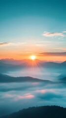 Fototapeta premium Sunrise over the mountains, a beautiful landscape with misty peaks and a blue sky