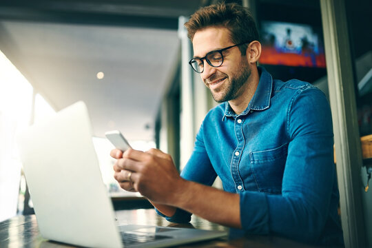Business man, phone and laptop for networking, research and project management with kpi app in office. Employee, happy and mobile in workplace for communication, investment growth and revenue report