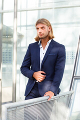 Handsome Young Man in Blue Suit Posing Outdoors