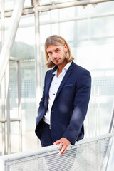 Handsome Young Man in Blue Suit Posing Outdoors