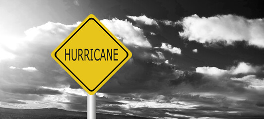 danger,caution,Hurricane Idalia warning sign against a powerful stormy background with copy space. Dirty and angled sign with cyclonic winds add to the drama.hurricane season sign on cloudy background
