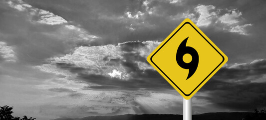 danger,caution,Hurricane Idalia warning sign against a powerful stormy background with copy space. Dirty and angled sign with cyclonic winds add to the drama.hurricane season sign on cloudy background