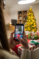 woman filming christmas with mobile phone