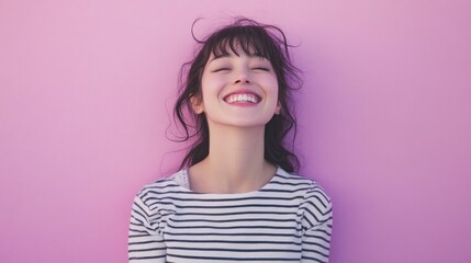 Fototapeta premium Woman in soft pastel purple, cheerful and relaxed, wearing a striped shirt in a simple and minimalist setting