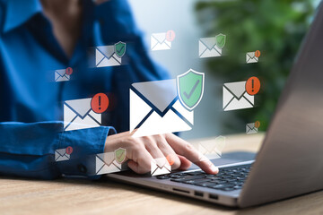 Email Alert, Email from Scammers Protection concept, Businesswomen use a laptop and decide to open...