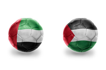 football balls with national flags of palestine and united arab emirates ,soccer teams. on the...