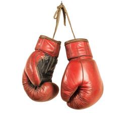 Vintage red boxing gloves hanging in a gym