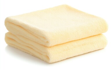 Soft and cozy yellow towel stacked neatly, perfect for spa, bath, or beach settings. Ideal for relaxation and comfort.