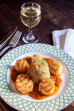 Seared scallops and Quinoa pilaf plate on table