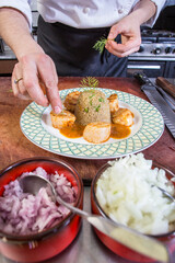 Close up of chef plating scallop plate