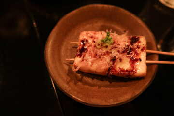 close up of Japanese deep fried tofu bean curd skewer with sauce and spring onion