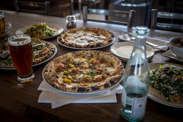 Gourmet Pizzas on table in Italian restaurant