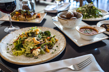 Dinner in a restaurant with a table full of food, Salad