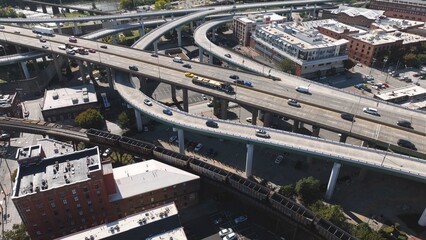 Aerial interstate travel through River Richmond, VA city downtown with cars and trucks traveling on interstate highway through big city