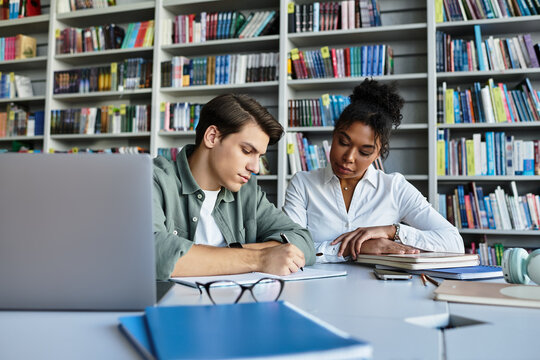 A passionate educator helps a young student with their studies at a local library.