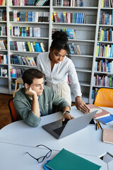 A teacher assists her young student with a laptop as they explore learning together.