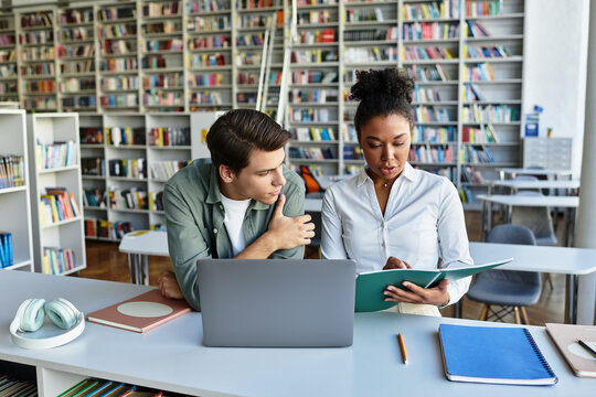 A dedicated teacher supports her eager student as they explore educational materials together.