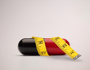 Weight loss pill with a measure tape