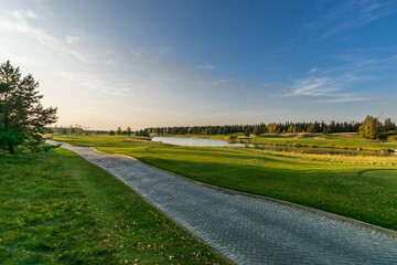 Beautiful view of the golf club grounds with fields and driveways on a clear autumn day.