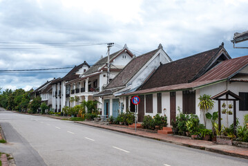 Naklejka premium Quiet street with white colonial houses in the center of Luang Prabang, Laos, Asia