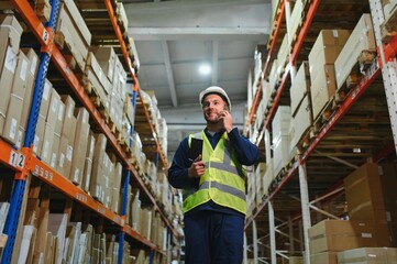 Warehouse, shipping and man walking in a distribution, freight and supply chain company. Worker, contractor and back with stock, factory and export business with employee working with storage