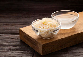 Organic coconut water in glass bowl - Cocos nucifera.