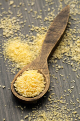 Japanese yellow panko crumbs on wooden spoon.