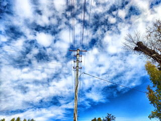 Old pole with wires against the sky. Electric transmission line. Eco-friendly energy