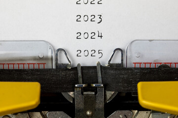 2023, 2024, 2025,2026 written on an old typewriter	