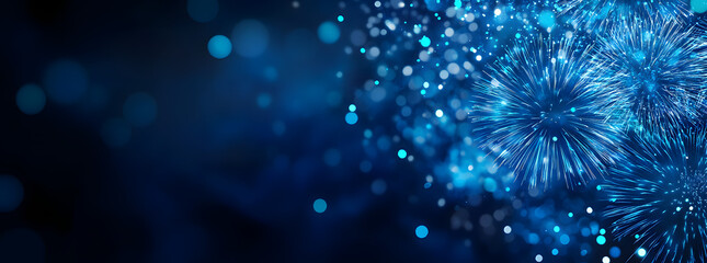 Fototapeta premium Blue fireworks against a dark blue sky background with copy space, a banner design. New year celebration concept.