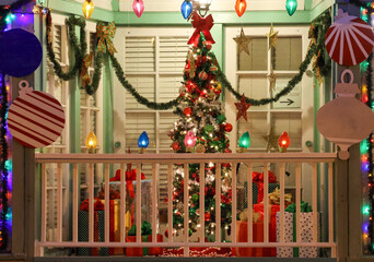 Colorful Christmas decorations lighting up a balcony during the holidays.