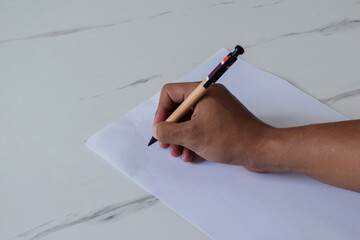 young man writing on blank paper