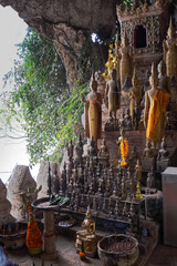 The statues of Buddha with different sizes are arranged in a way that creates a sense of reverence and respect for the religious at  the Pak Ou cave mount in Luang Prabang, Laos.