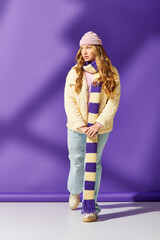 A stylish young woman in a vibrant outfit enjoys a moment of self expression in winter fashion.
