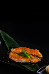 Teriyaki salmon Japanese cuisine Japanese food grilled salmon fillet in teriyaki sauce Isolate in black background