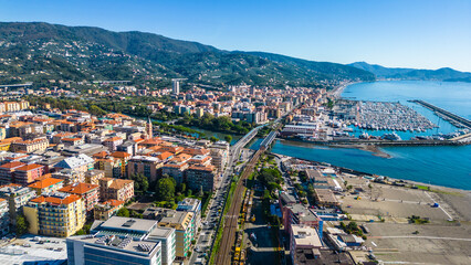 Chiavari, a charming coastal town in Italy's Liguria region, viewed from the air showcases its scenic waterfront, vibrant marina, and historic architecture nestled between the green hills