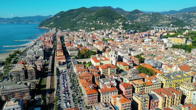 Chiavari, a charming coastal town in Italy's Liguria region, viewed from the air showcases its scenic waterfront, vibrant marina, and historic architecture nestled between the green hills