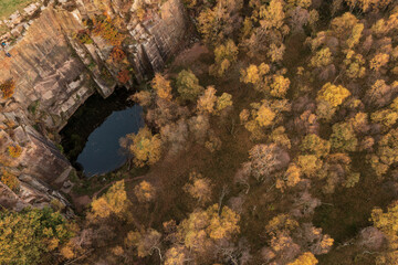 Dramatic aerial drone landscape image of Autumn Fall forest in misty morning in Peak District during peak colour
