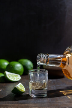 Tequila being poured into shot glass 