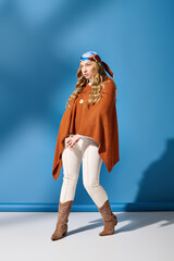 Fototapeta premium The young woman showcases a fashionable look with confidence against an eye catching backdrop.