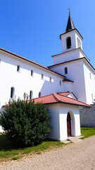 white building with a tower red roof